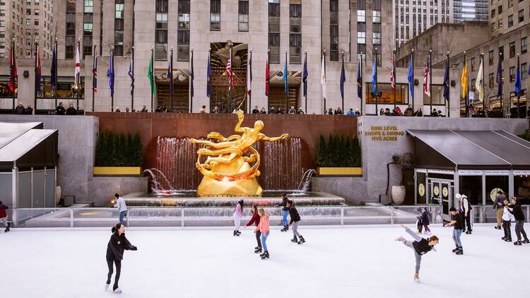 People skate on an ice rink.