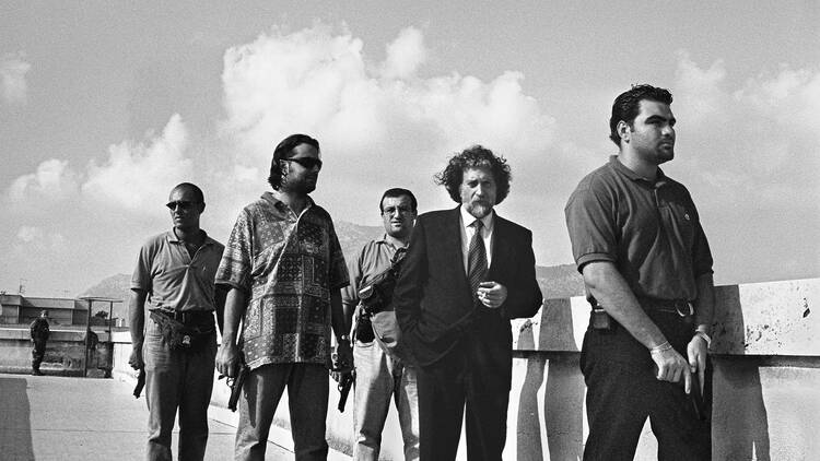 Letizia Battaglia, Magistrate Roberto Scarpinato with his escort on the roofs of the Court. © Courtesy Archivio Letizia Battaglia