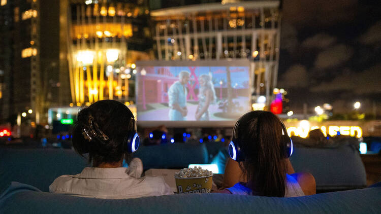 People watching a film on a large cinema screen.