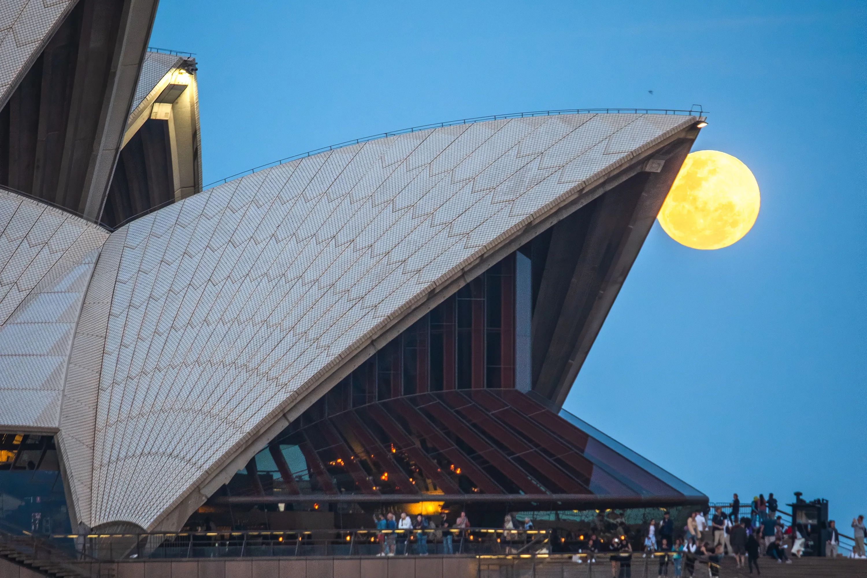 Supermoon peaking out of Sydney Opera House sail
