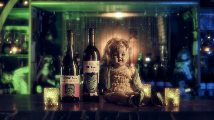 Creepy doll sitting in the Possessed Wine Bar.