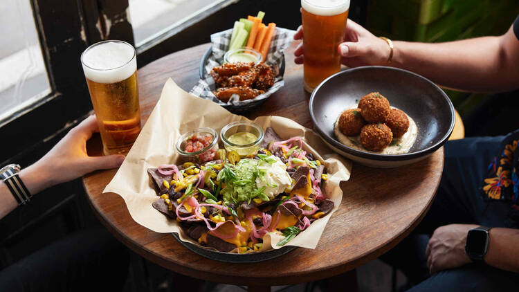 Nachos, arancini and beer at pub