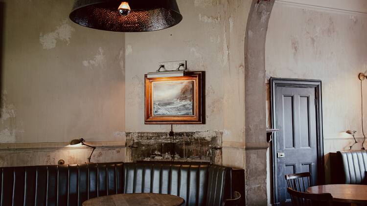 Inside of pub with green banquettes