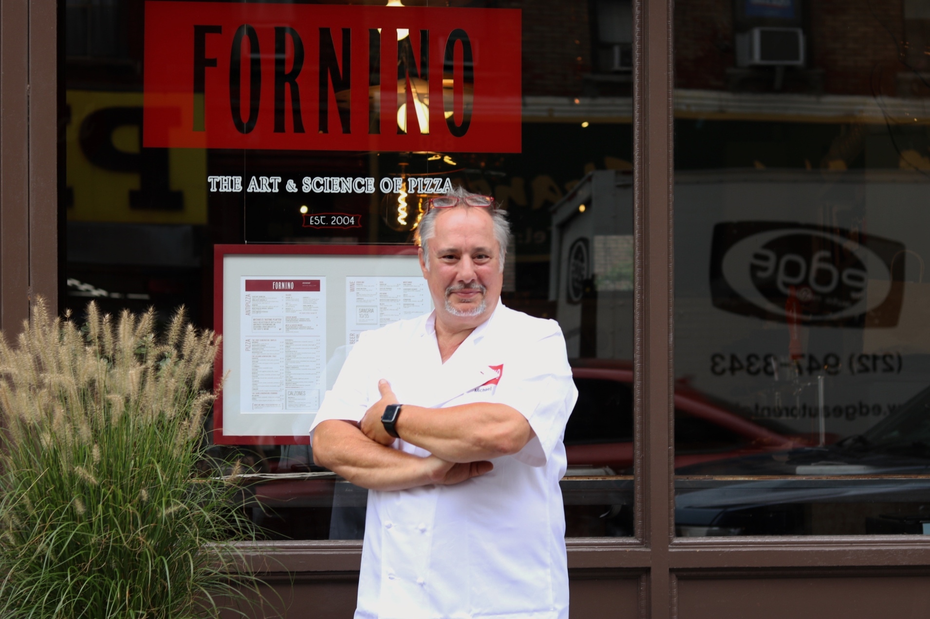 Michael Ayoub standing outside of his restaurant