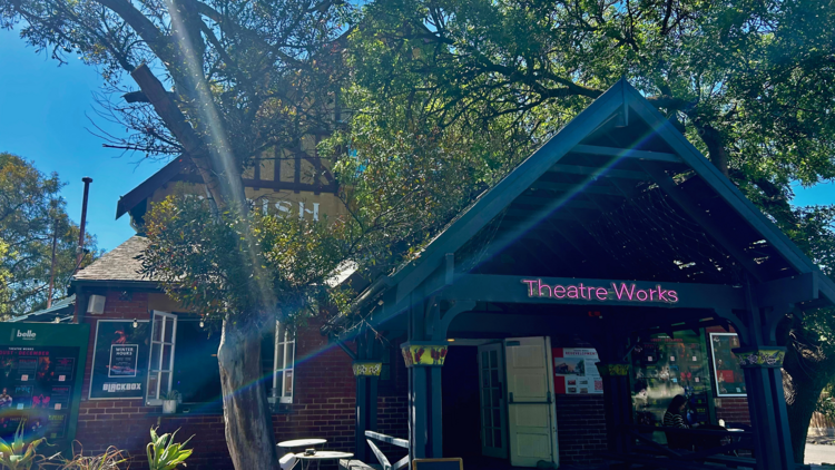 The outside of the timber theatre works building with trees and blue sky in the background