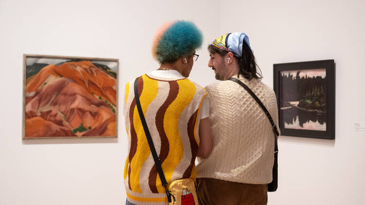 Two people look at artwork at the Whitney museum.