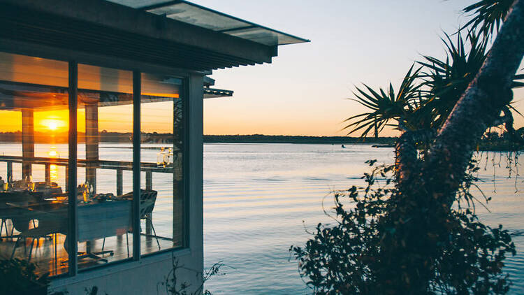 Restaurant overlooking water at sunset