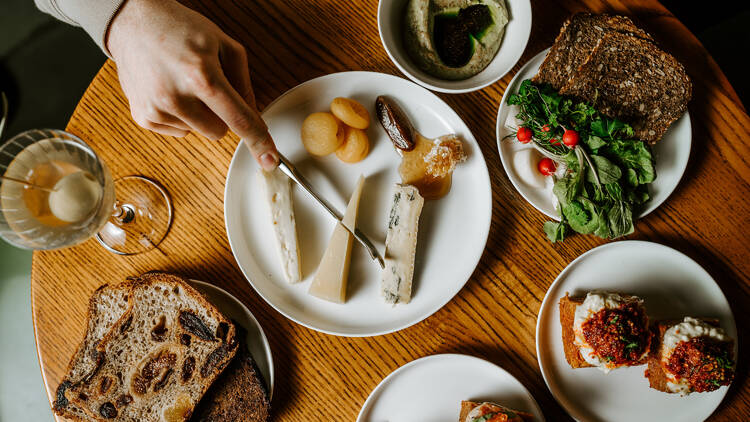 A table of food, including bread, cheese and dips.