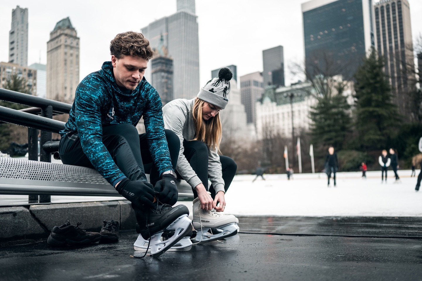 Skaters at The Wollman Rink with skyline in the background.