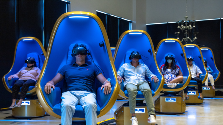 people sitting chairs for vr experience