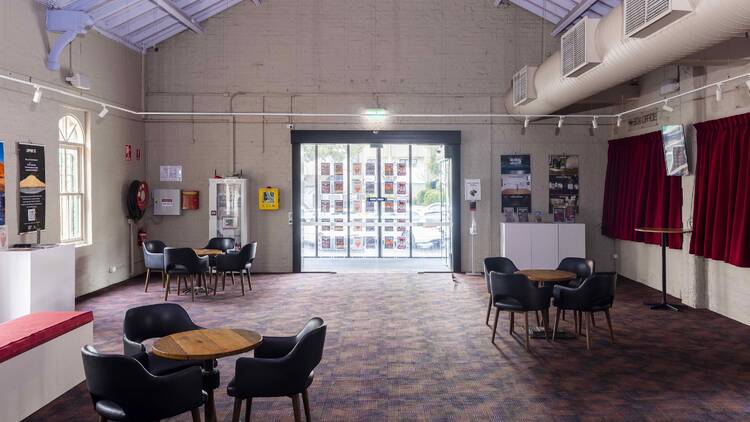 A foyer with tables and chairs. 