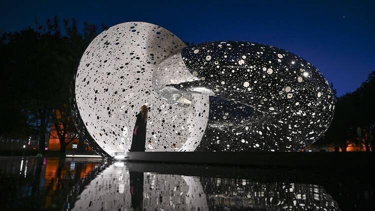 Black and white reflective art installation at night