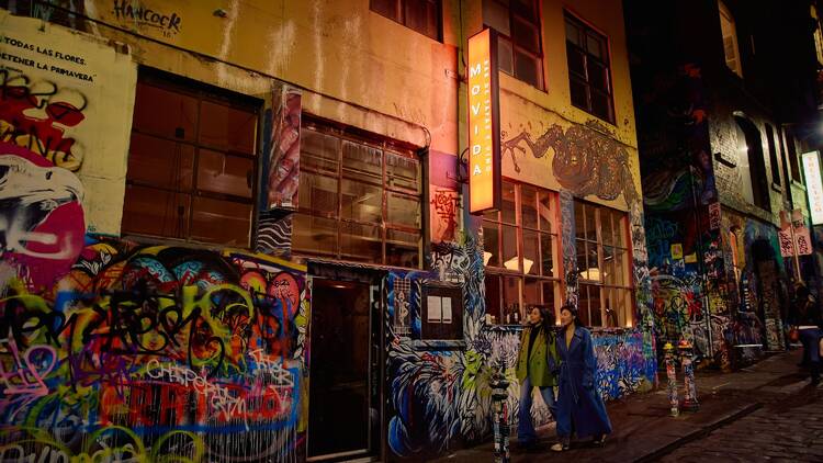 Two people walking up to Movida in Hosier Lane.