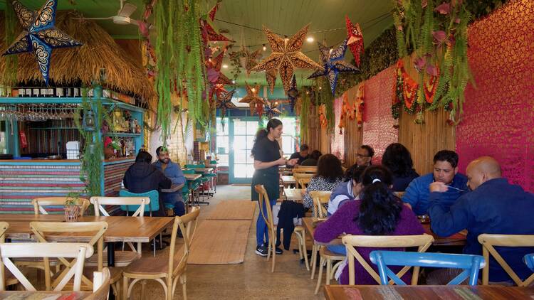 Waitress serving customers at Babaji's.