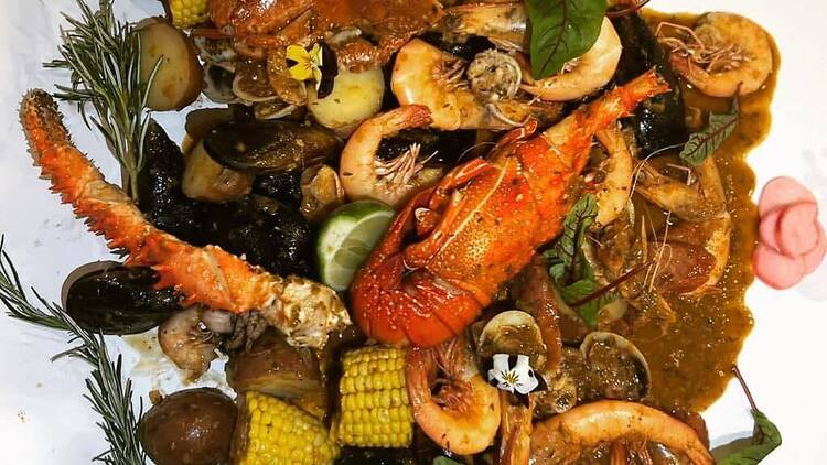 A seafood boil on a white paper tablecloth.