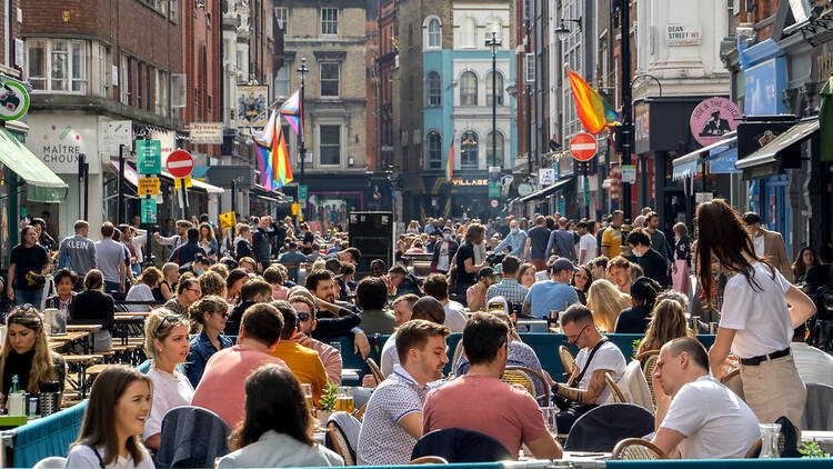 People sitting outside in Soho 