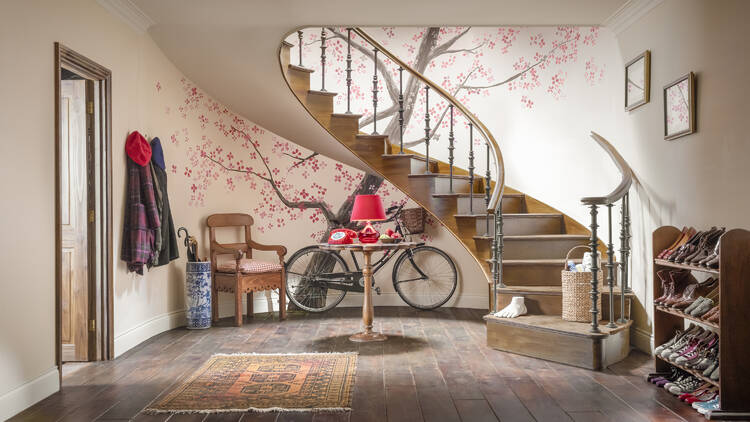 Spiral staircase and blossom tree mural in Paddington's house 