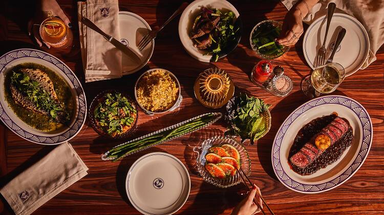 A wooden table filled with dishes 