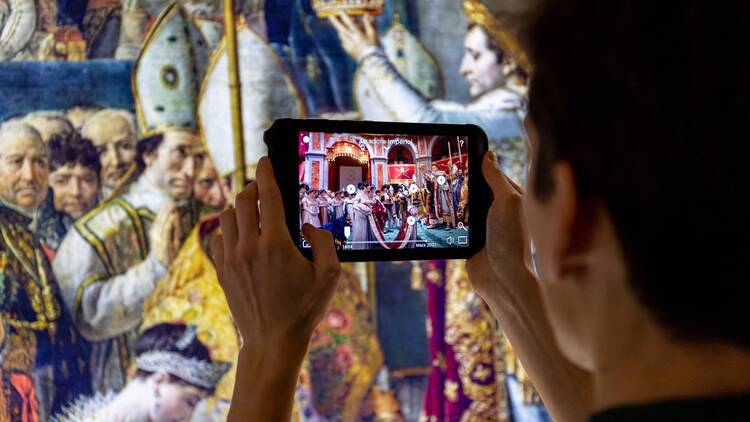 An exhibit-goer uses a tablet in the Notre Dame exhibit