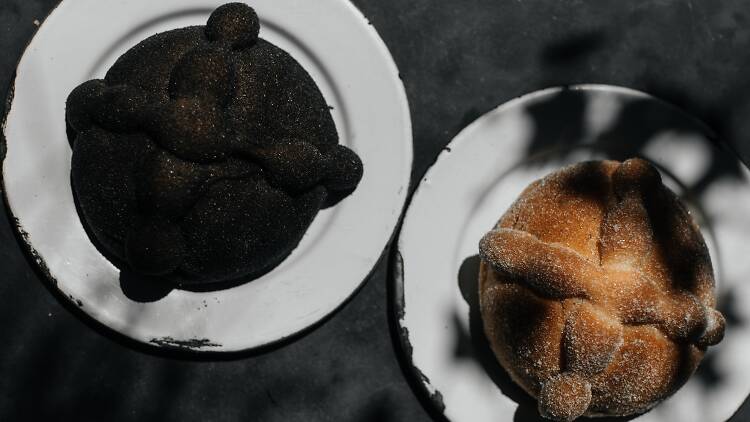 Two pan de muertos, one traditional and the other black