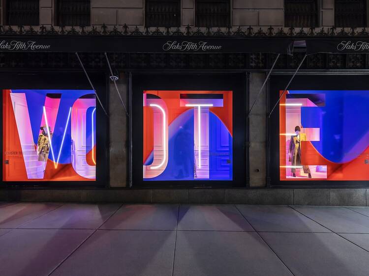 A red-white-and-blue sign reading VOTE in the Saks windows.