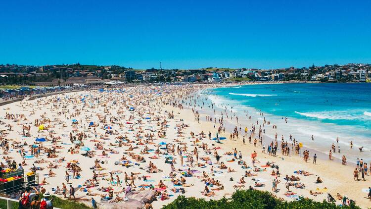 Sunbathers and swimmers on Bondi Beach on a sunny day in Sydney, Australia