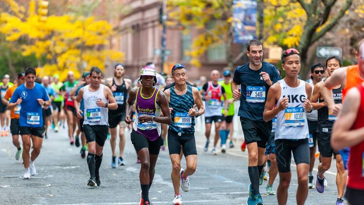 Runners pass through Harlem in New York near the 22 mile mark near Mount Morris Park in the running of the TCS New York City Marathon