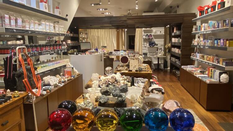 A store with shelves stocked with beauty products and crystals. 