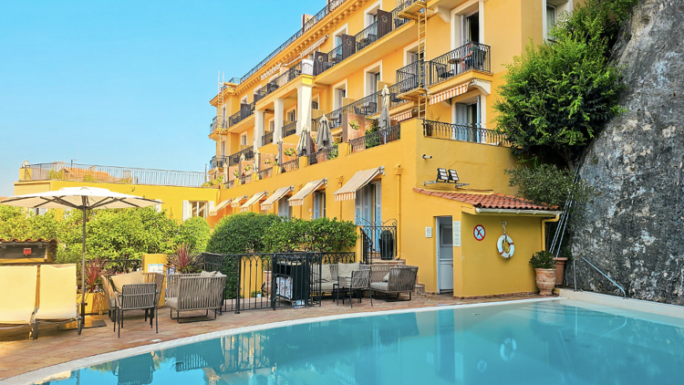 Outdoor pool area of hotel Perouse