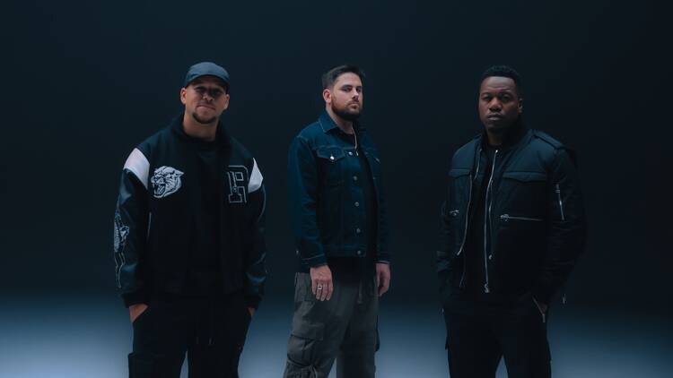 Rudimental band posing in dark