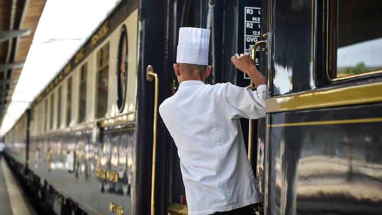 Orient Express train with chef leaning out of door