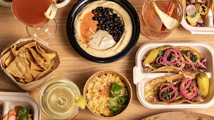 A table full of Mediterrnean and Mexican dishes