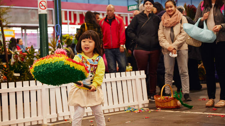 A child hitting a pinata. 