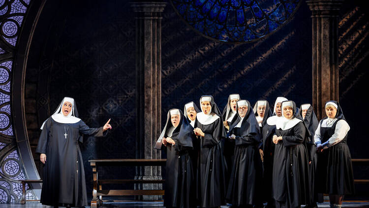 Casey Donovan and the cast of Sister Act on stage in nun outfits.