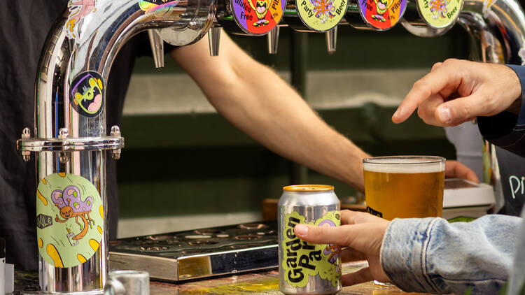 A bartender pours a drink for pub-goers on the Blackhorse Beer Mile