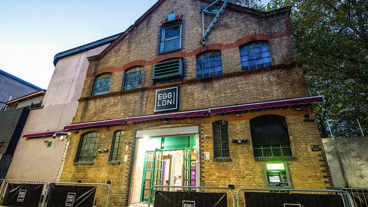 A photograph of Egg nightclub at dusk, showing a lit Victorian building with open doors.