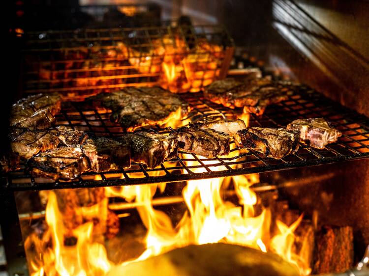 Steaks cooking over fire