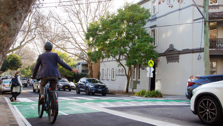 Male bike rider turning to Ridge Street of West Street in North Sydney