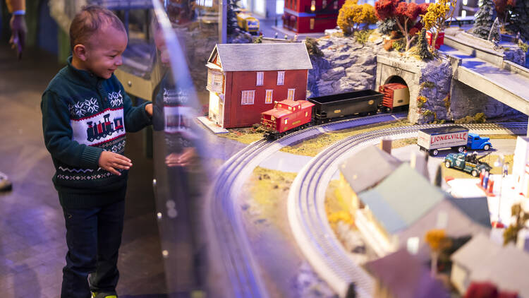 A child looks at a train display.