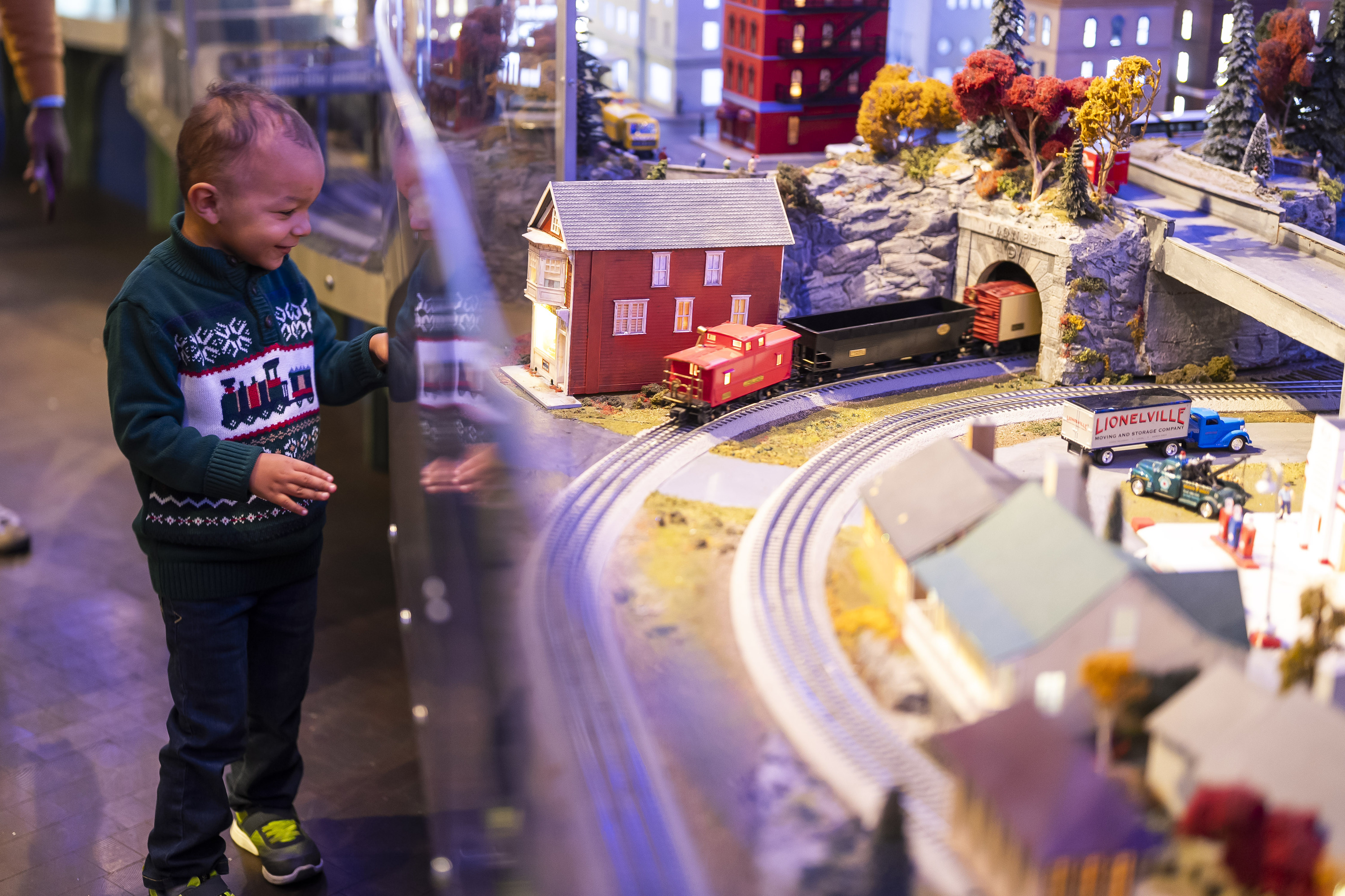 A child looks at a train display.