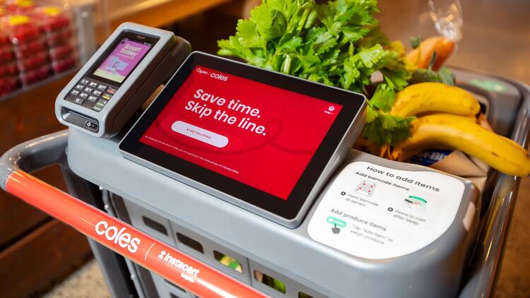 A shopping trolley with a digital screen and an Eftpos machine 