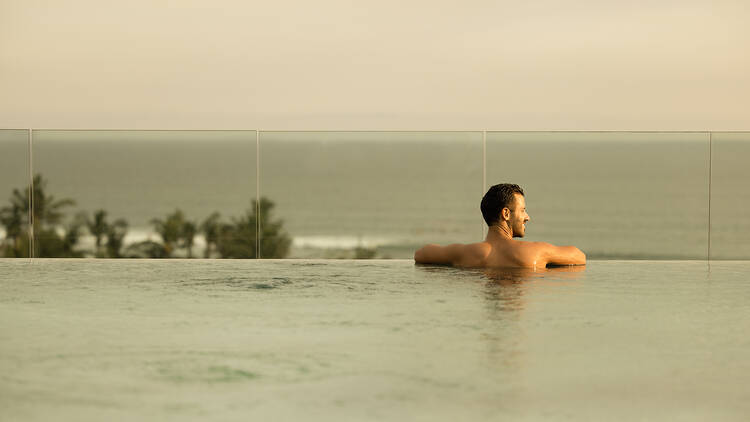 A man in a pool with a view