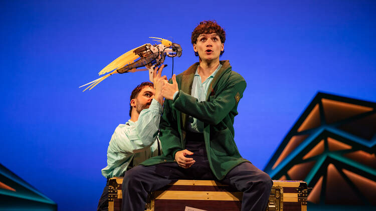 Actor Otis Dhanji on stage with a puppet in Peter and the Starcatcher.