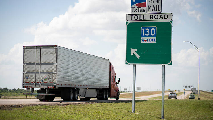 Truck passing TxTag toll road sign