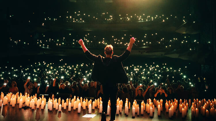 A concert with a lot of candlelights 