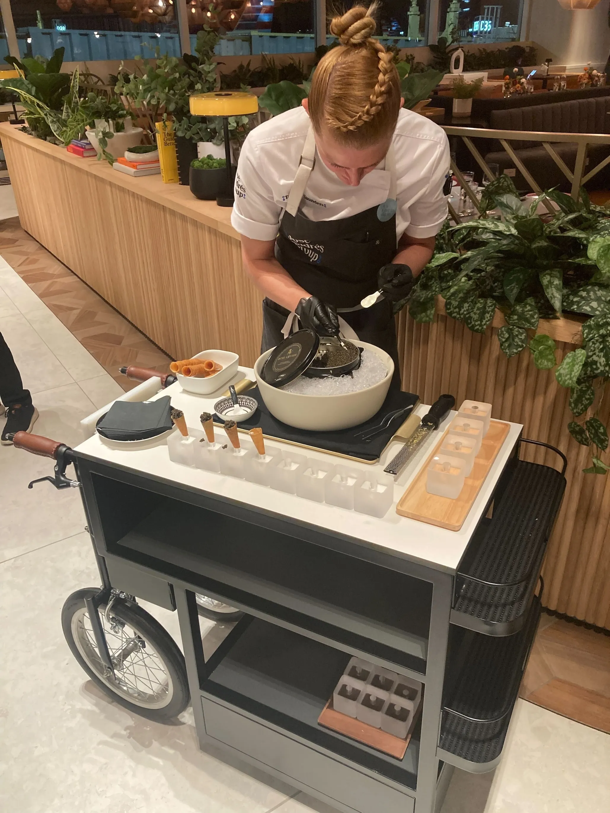 A staff member fills cones with labneh and caviar at Capital One Landing at DCA.
