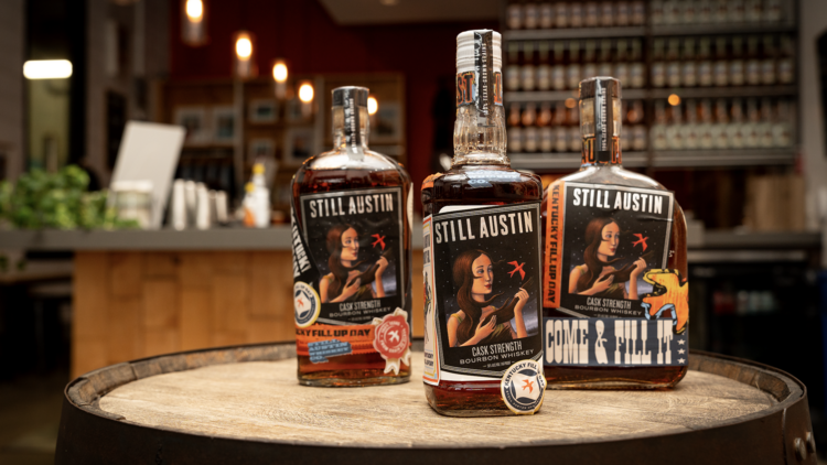 Three bottles on barrel from Still Austin Whiskey Co. 