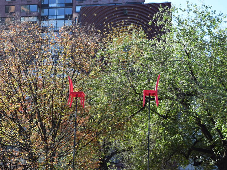 There are two whimsical pink chairs floating over Union Square right now