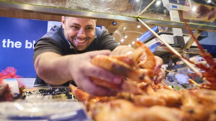 Guy holding prawns