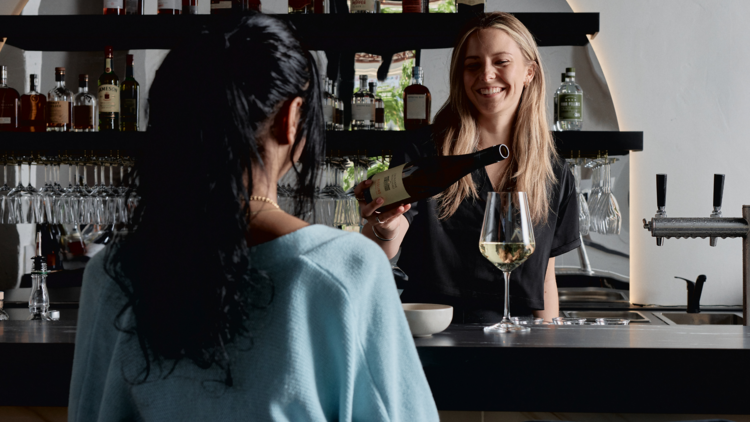 Bartender serving wine at Marama Wine Bar.